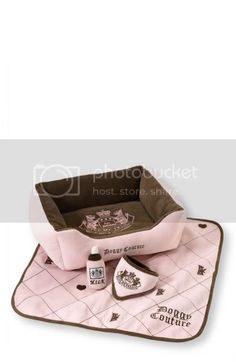 a pink and brown dog bed with accessories