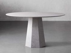 a white marble table sitting on top of a gray floor