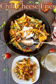 a skillet filled with cheesy fries next to a glass of milk