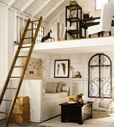 a loft bed with a ladder in the middle and pictures on the wall above it