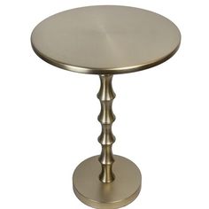 a round metal table sitting on top of a white floor