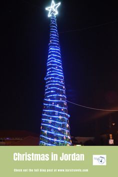 the christmas tree is lit up in blue and white lights with a star on top