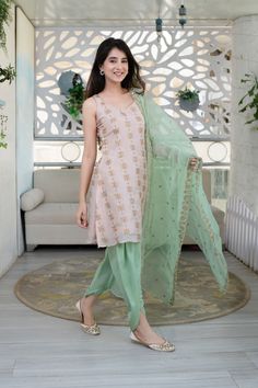 Trendia brings you Peach and Pista kurta and dhoti pants set with Dupatta by the brand Lable Shaurya Sanadhya. This Indian Ethnic wear includes a Peach Kurti of Upada Silk with zari work, a Santoon Pista dhoti pants with Pista Organza Dupatta with zari work all over it. This short Kurta for women is sleeveless with. The Indian Kurta has a sweetheart neck both front and back and a dori tassle tie-up at the back. Kurta:Fabric - Upada SilkColour – PeachNeck – Sweetheart neckSleeves- SleevelessWork- Peach Kurti, Short Kurta For Women, Shaurya Sanadhya, Patiala Dress, Sleeveless Kurta, Silk Kurti Designs, Indian Suit, A Line Kurti, Organza Suits