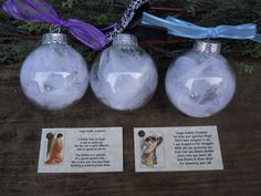 three glass ornaments with cards attached to them