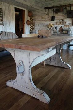 a large wooden table sitting on top of a hard wood floor