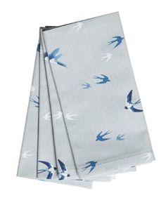 three napkins with blue birds on them