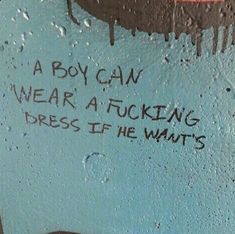 graffiti written on the side of a blue wall