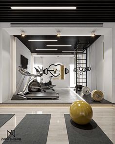 there is a gym with exercise equipment in the room, and an exercise ball on the floor