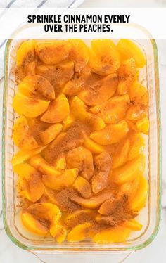 a casserole dish filled with sliced peaches and cinnamon in a glass baking dish