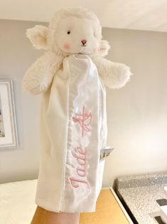 a white teddy bear wrapped in a towel