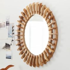 a mirror that is on the wall next to a table