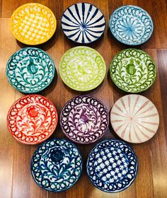 many colorful bowls are arranged on the floor