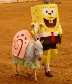 a costumed animal is standing next to a person in a costume that looks like spongebob