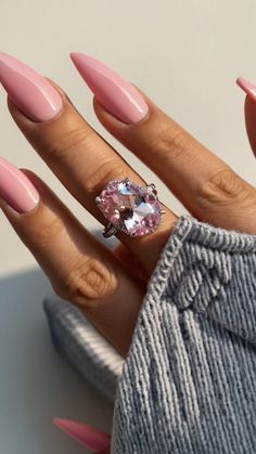 a woman's hand with pink manies and a ring on her left hand