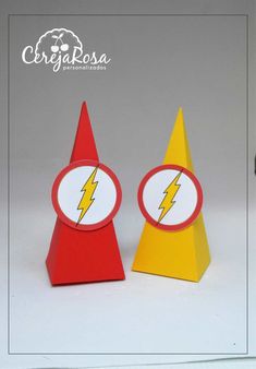 two paper cones with lightning symbols on them, one is red and the other is yellow