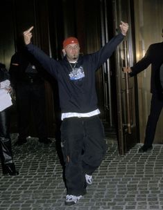 a man in black shirt and red hat dancing