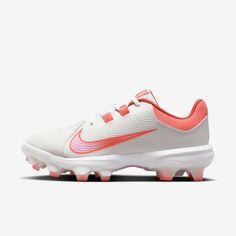 a white and pink nike vapor soccer shoe with an orange stripe on the soles