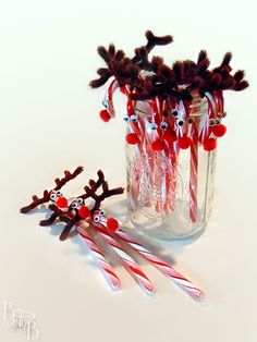 some candy canes are sitting in a glass vase