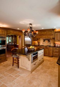 a large kitchen with wooden cabinets and an island in front of the stove top oven