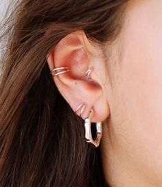 a close up of a person with ear piercings