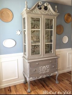 an antique china cabinet painted in blue and white