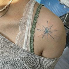 a woman with a star tattoo on her shoulder