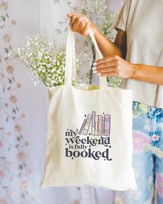 "The perfect tote to show the world your weekend is booked! This 100% cotton canvas bag is the most stylish way to announce you're busy to the world. With a 12\" x 14\" size, it's perfect for carrying your must-haves. Get ready to receive compliments! https://mariecraftcodesigns.myshopify.com" Cotton Tote Bag With Bookish Style, Bookish Cotton Tote Bag, Cotton Canvas Bag With Letter Print For Weekend, Ready To Receive, Book Tote Bag, Canvas Bags, Book Lovers Gifts, Printed Tote Bags, Book Lover