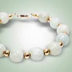 Beautiful white Jade represents purity and spirituality. These gorgeous beads are enhanced by gold-filled spacers for a sophisticated look. White Jade (11mm) Gold-filled Length: 8.5" Different Jade colors and sizes available, on request White Single Strand Jade Jewelry, Elegant Jade Beaded Bracelets With Polished Beads, White Jade Jewelry With 8mm Beads, Elegant Jade Jewelry With Spacer Beads, Elegant Jade Jewelry With Large Beads, Elegant Beaded Bracelets For Meditation, Elegant Jade Bracelets With Polished Beads, Elegant 8mm Beads Bracelet For Meditation, Elegant White Bracelets With Large Beads