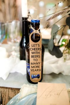 a bottle of beer sitting on top of a table next to a plate and napkin