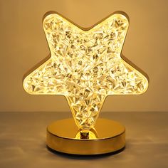 a golden star shaped light on a stand