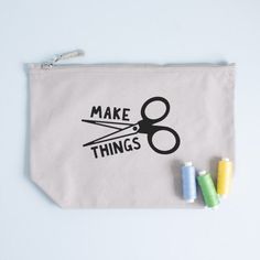 a white bag with scissors and some crayons on it that says make things