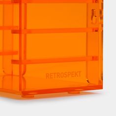 an orange plastic object with the words retrospekt on it's side