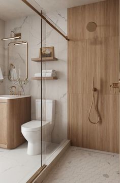 a white toilet sitting next to a walk in shower under a bathroom mirror on top of a wooden shelf