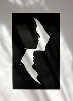 a black and white image of two women's faces on a sheet of paper