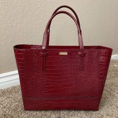 Nwot Kate Spade Riverside Street Exotic Bedford In Merlot. New Without Tags, Never Used. Large Tote Shoulder Bag Features A Crocodile Embossed Leather, Top Zip Closure, Gold Staple Kate Spade New York Signature, Capital Kate Jacquard Lining. Inside Zip And Open Multifunction Compartments. Measures Approximately 14.2" Wide At The Bottom Tapers To 20" Wide At The Top, By 12.1" High By 5.3" Deep With The Straps Having A Drop Of 7.1" Absolutely Stunning Bag, Just Larger Than I Need Merlot, Kate Spade Bag, Large Tote, Leather Top, Michael Kors Jet Set, Kate Spade Top Handle Bag, Kate Spade New York, Womens Tote Bags, Embossed Leather