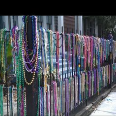 a fence covered in lots of different colored beads