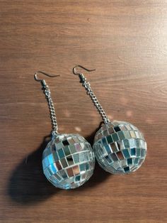 Super cute disco ball earrings. Ball itself is about 1.5 inches in diameter. Chain is about an inch and a half long. Earring hook is nickel free. Made of styrofoam and glass/mirror tiles. There are some bare areas, due to shape of tiles and shape of ball, as pictured. Disco Ball Earrings, Taylor Swift Tour Outfits, Funky Earrings, Mirror Ball, Bohol, Ball Earrings, Concert Fits, Funky Jewelry, Chic Jewelry