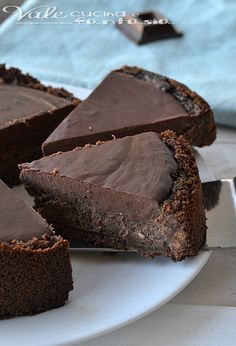 there is a piece of chocolate pie on the plate with one slice cut out and ready to be eaten