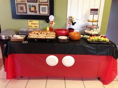 a table topped with lots of food on top of a tiled floor next to a wall