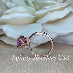 "This ring is a round cut lab created pink sapphire solitaire in 14k rose gold #6465 -Approximate total carat weight: 2.70ctw. diamond equivalent -Center Stone Size: approx. 2.70ct diamond equivalent -Center Stone Shape: round cut / 9 MM -Gem Type: lab created pink sapphire -Stone Clarity: VS2 -Stone Color: Medium Pink -Moh's Scale: 9 hardness -Metal Type and Purity: 14k rose gold -Setting: classic Tulip 4 Prong Setting -Stock Ring Size: 6 -Country of Manufacturing: USA (Michigan) For customizat Pink Sapphire Promise Ring With Vvs Clarity, Fine Jewelry Pink Gold Sapphire Ring With Pink Sapphire, Pink Gold Round Ruby Ring With Prong Setting, Pink Sapphire Ring With Ethical Diamonds, Pink Gold Ruby Ring With Prong Setting, Pink Sapphire Promise Ring In Round Cut, Pink Sapphire Ring In 14k Gold With Prong Setting, Pink Sapphire Ring With Round Cut For Anniversary, Pink Sapphire Ring With Center Stone For Anniversary