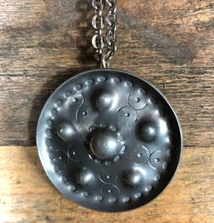 "Vintage pewter pendant necklace by Jorgen Jensen, Denmark. The hand made pendant is round with a nice pattern and raised edges. The diameter measures 2\" / 5cm and the chain measures 36\" / 91cm. Marked: \"PEWTER Jorgen Jensen HANDMADE DENMARK 158\" It's from the 1960's and shows minor wear, such as small scratches, for it's age. Please see all pictures." Viking Shield, Vintage Pewter, Scandinavian Folk Art, Pewter Pendant, Family Keepsakes, Vintage Mid Century Modern, Danish Modern, Candlestick Holders, Tapestry Wall Hanging