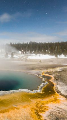 an aerial view of the yellowstone river in winter with snow on the ground and trees around it