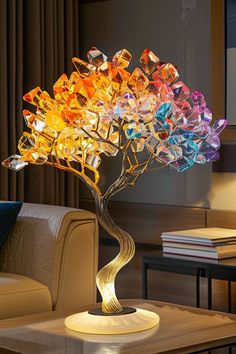 a table with a lamp on top of it and a tree made out of glass blocks