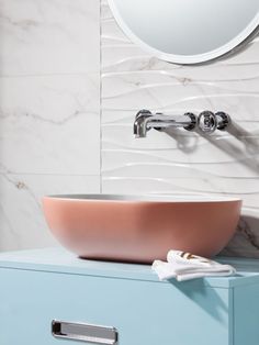 a bathroom sink sitting on top of a blue cabinet