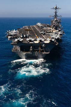 an aircraft carrier in the middle of the ocean