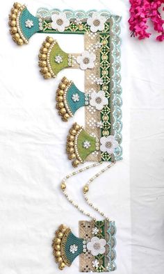 an intricately decorated wall hanging with flowers and beads