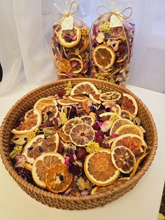 a basket filled with orange slices and dried flowers