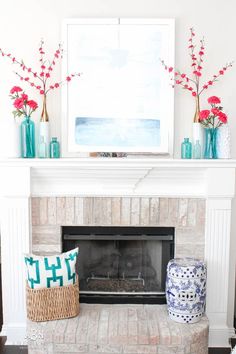 a living room filled with furniture and a fire place in front of a white fireplace