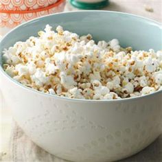 a bowl filled with popcorn sitting on top of a table