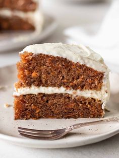 a slice of carrot cake on a plate with a fork